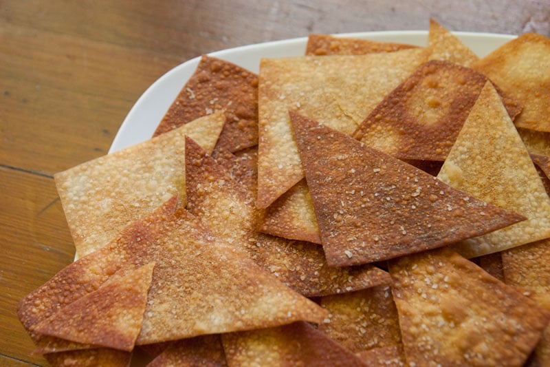 Potsticker Nachos with Baked Sesame Ginger Wonton Chips | Enjoy the juicy, gingery gyoza filling in a crunchy, fun, easy-to-share format. These Asian-inspired nachos are sure to be a hit! | www.pinchmeimeating.com