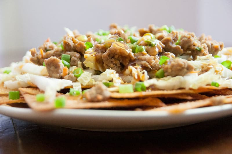 Potsticker Nachos with Baked Sesame Ginger Wonton Chips | Enjoy the juicy, gingery gyoza filling in a crunchy, fun, easy-to-share format. These Asian-inspired nachos are sure to be a hit! | www.pinchmeimeating.com