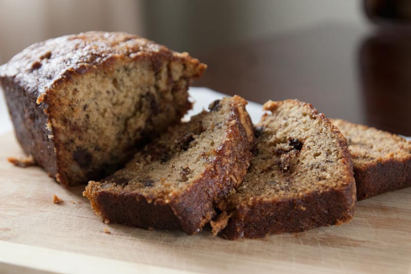 The moistest, meltiest, most delicious chocolate chip banana nut bread you'll ever taste. In the oven in only 20 minutes, and it's great for breakfast AND dessert! | www.pinchmeimeating.com
