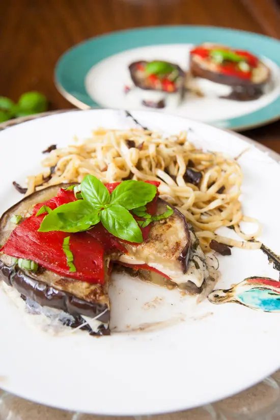 These grilled balsamic eggplant stacks are full of oh-so-melty mozzarella cheese, smoky roasted red peppers, and basil, and are perfect for a light dinner! | www.pinchmeimeating.com