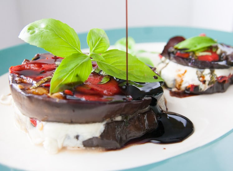 These grilled balsamic eggplant stacks are full of oh-so-melty mozzarella cheese, smoky roasted red peppers, and basil, and are perfect for a light dinner! | www.pinchmeimeating.com