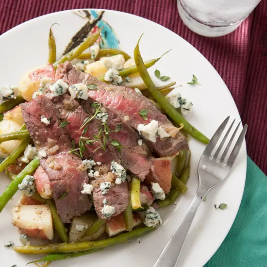 This potato, green bean, and steak salad is topped with blue cheese and has a vinaigrette dressing so delicious you'll want to lick the plate. | Pinch Me, I'm Eating!
