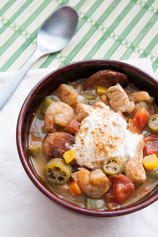 With chicken, shrimp, spicy andouille sausage, okra, and tons of other veggies, this gumbo is packed with FLAVOR and serves a crowd! | www.pinchmeimeating.com