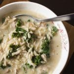Avgolemono Soup with Kale - This hearty Greek lemon chicken soup is chock full of orzo, shredded chicken, and kale and comes together in half an hour. Added eggs make the soup rich and creamy. So delicious, and I love how quick and easy it is! | www.pinchmeimeating.com