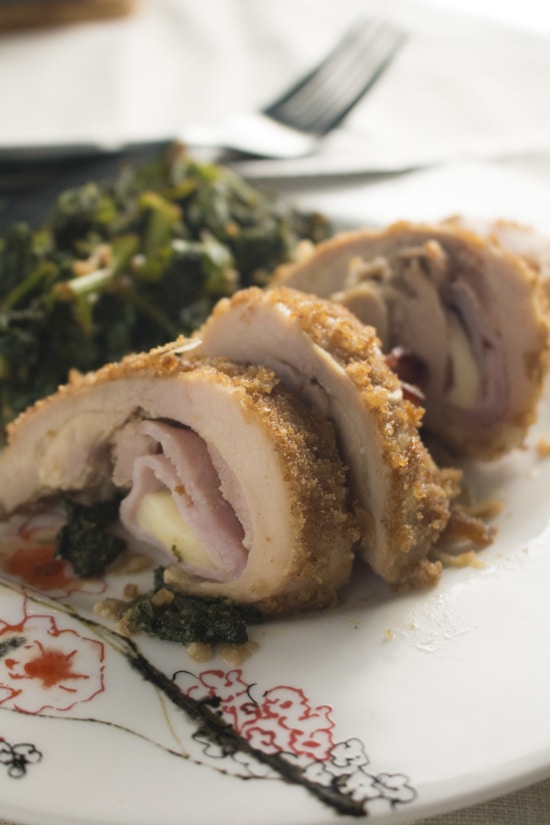 With ham, swiss, and a flavorful breading, this easy chicken cordon bleu is simple enough to make on a weeknight and fancy enough for a romantic Valentine's Day dinner! You can even make ahead of time and bake the day of. It's so juicy and flavorful! | www.pinchmeimeating.com