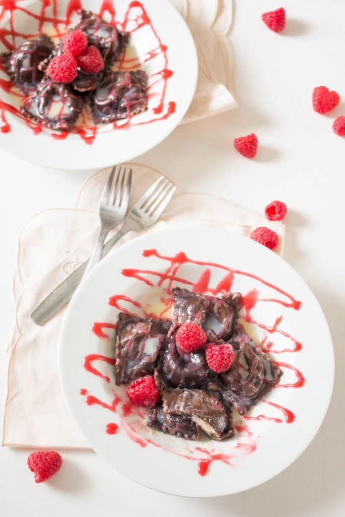 This chocolate ravioli with white chocolate mascarpone filling and raspberry sauce is an elegant, romantic, and unique dessert that is sure to impress! | www.pinchmeimeating.com