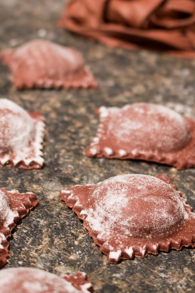 This chocolate ravioli with white chocolate mascarpone filling and raspberry sauce is an elegant, romantic, and unique dessert that is sure to impress! | www.pinchmeimeating.com