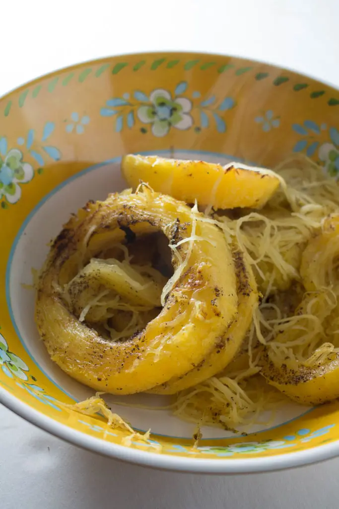 Spaghetti squash with mushrooms, walnuts, kale, and a nutmeg cream sauce is a naturally sweet, earthy dish that's simple to make, low carb, and gluten free. Great for Meatless Mondays or Meatless Fridays! There are also some great tips for the best way to cook a spaghetti squash! | www.pinchmeimeating.com