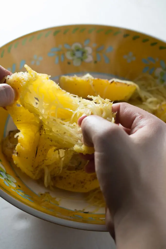 Spaghetti squash with mushrooms, walnuts, kale, and a nutmeg cream sauce is a naturally sweet, earthy dish that's simple to make, low carb, and gluten free. Great for Meatless Mondays or Meatless Fridays! There are also some great tips for the best way to cook a spaghetti squash! | www.pinchmeimeating.com