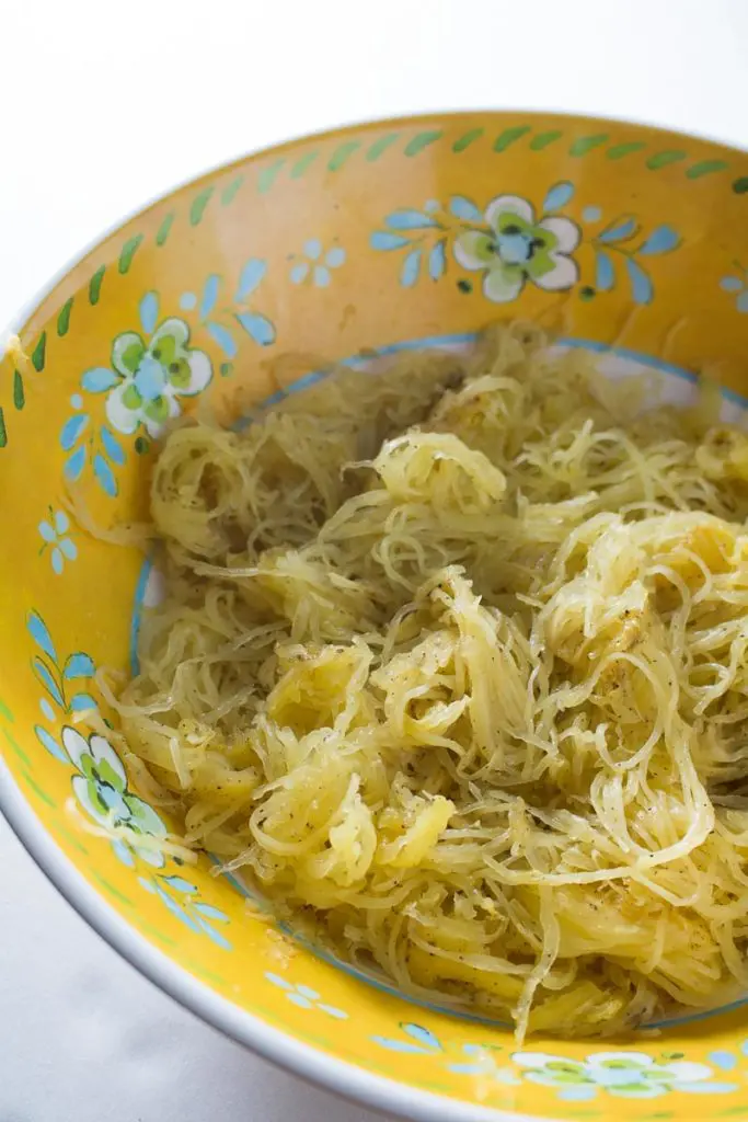 Spaghetti squash with mushrooms, walnuts, kale, and a nutmeg cream sauce is a naturally sweet, earthy dish that's simple to make, low carb, and gluten free. Great for Meatless Mondays or Meatless Fridays! There are also some great tips for the best way to cook a spaghetti squash! | www.pinchmeimeating.com