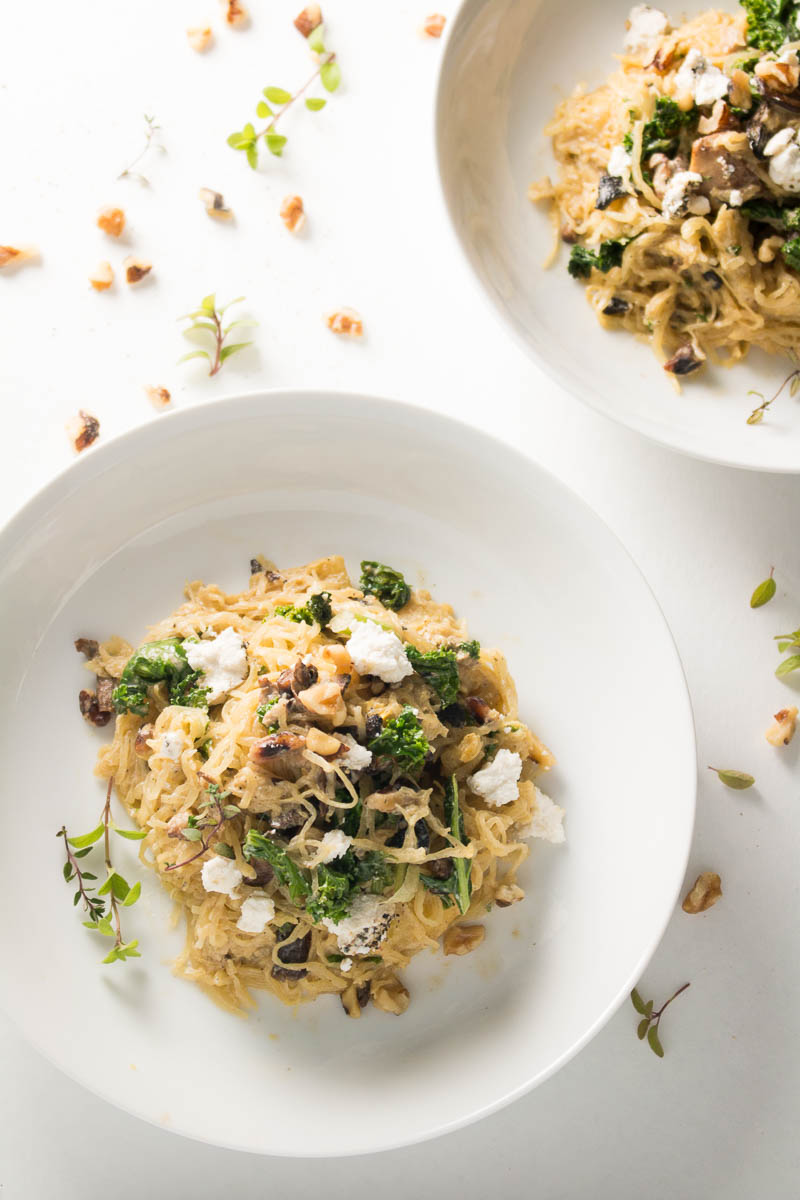 Spaghetti squash with mushrooms, walnuts, kale, and a nutmeg cream sauce is a naturally sweet, earthy dish that's simple to make, low carb, and gluten free. Great for Meatless Mondays or Meatless Fridays! There are also some great tips for the best way to cook a spaghetti squash! | www.pinchmeimeating.com