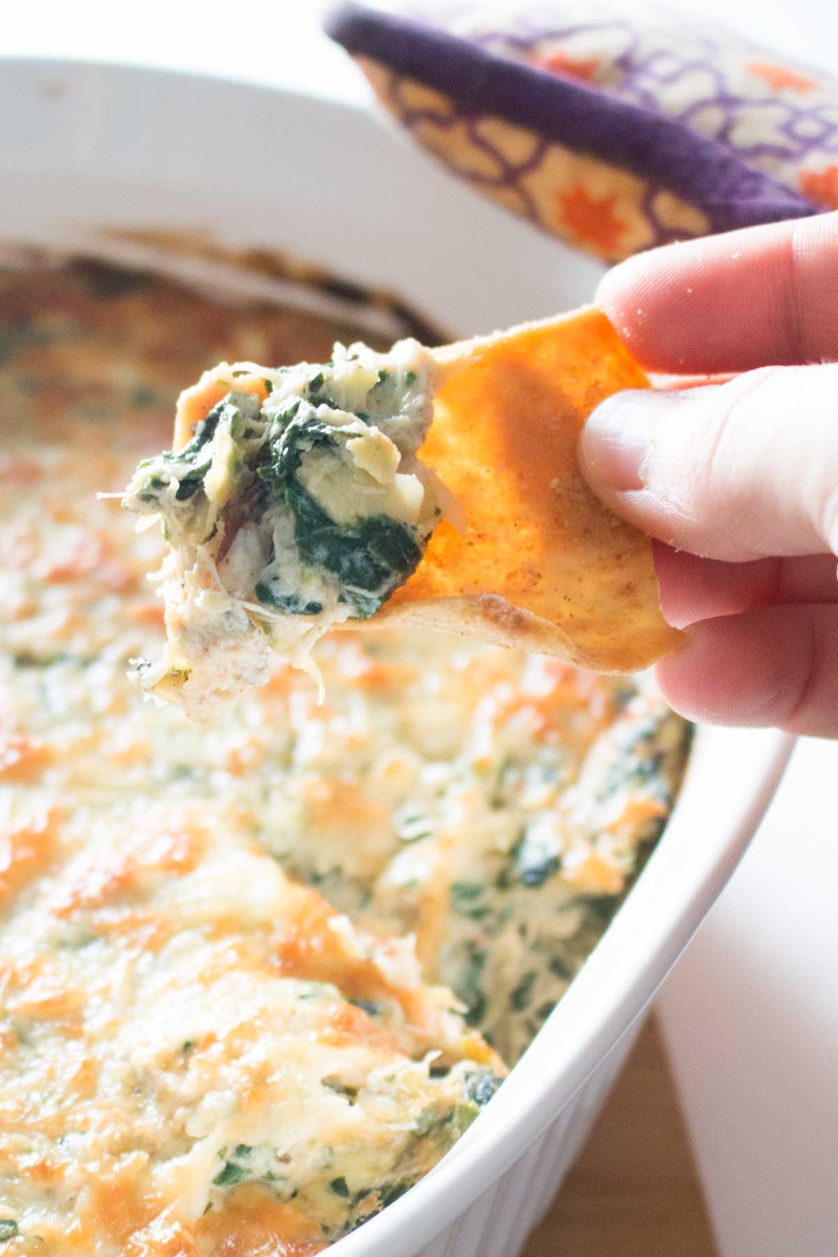 Pita chip with baked spinach, artichoke, and crab dip