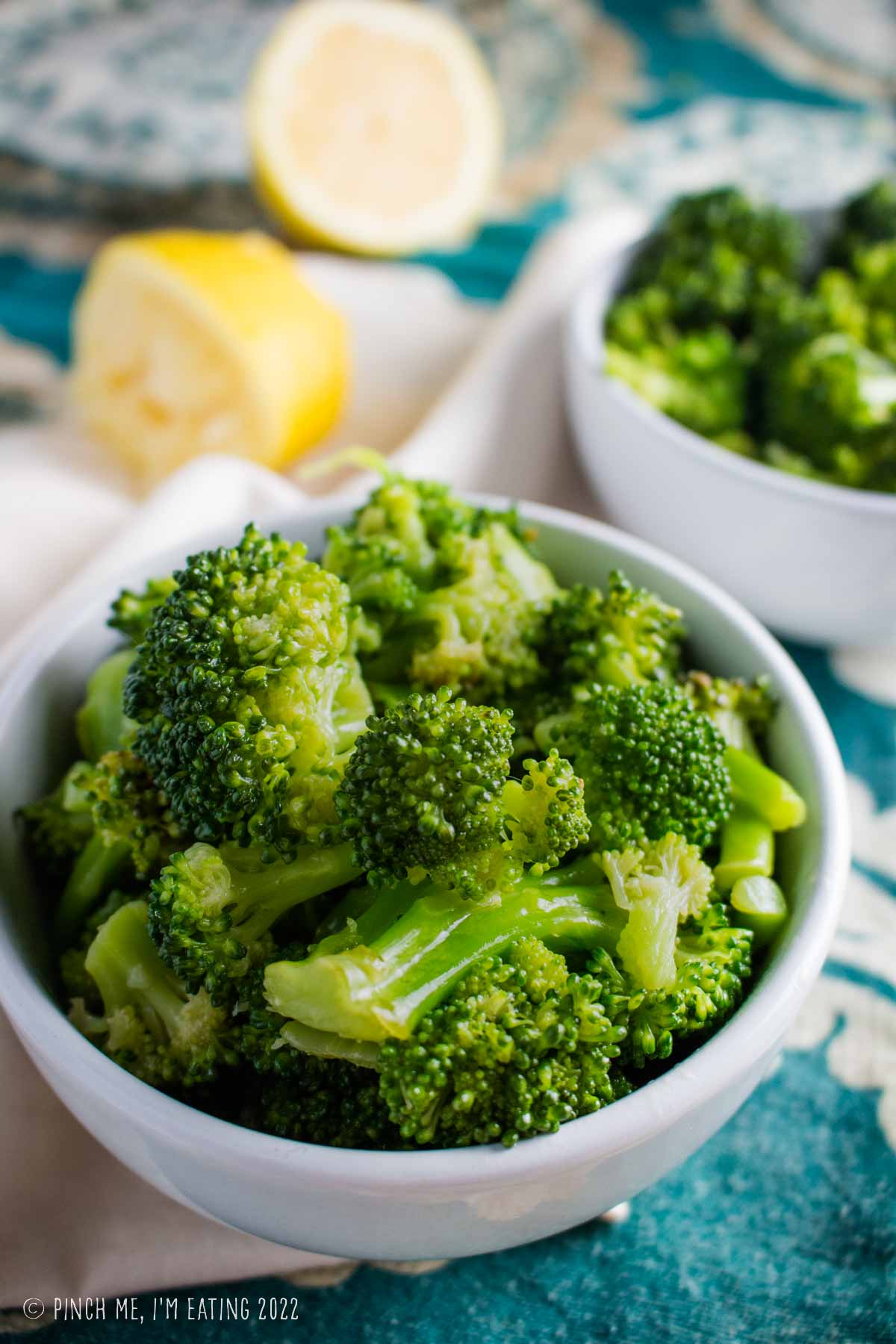 Simple lemon broccoli salad in a small white bowl.