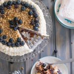 Blueberry spice cake with walnuts is layered with gooey blueberry jam and cream cheese frosting, and topped with walnuts and fresh berries for the perfect bite. A great cake for spring! | www.pinchmeimeating.com