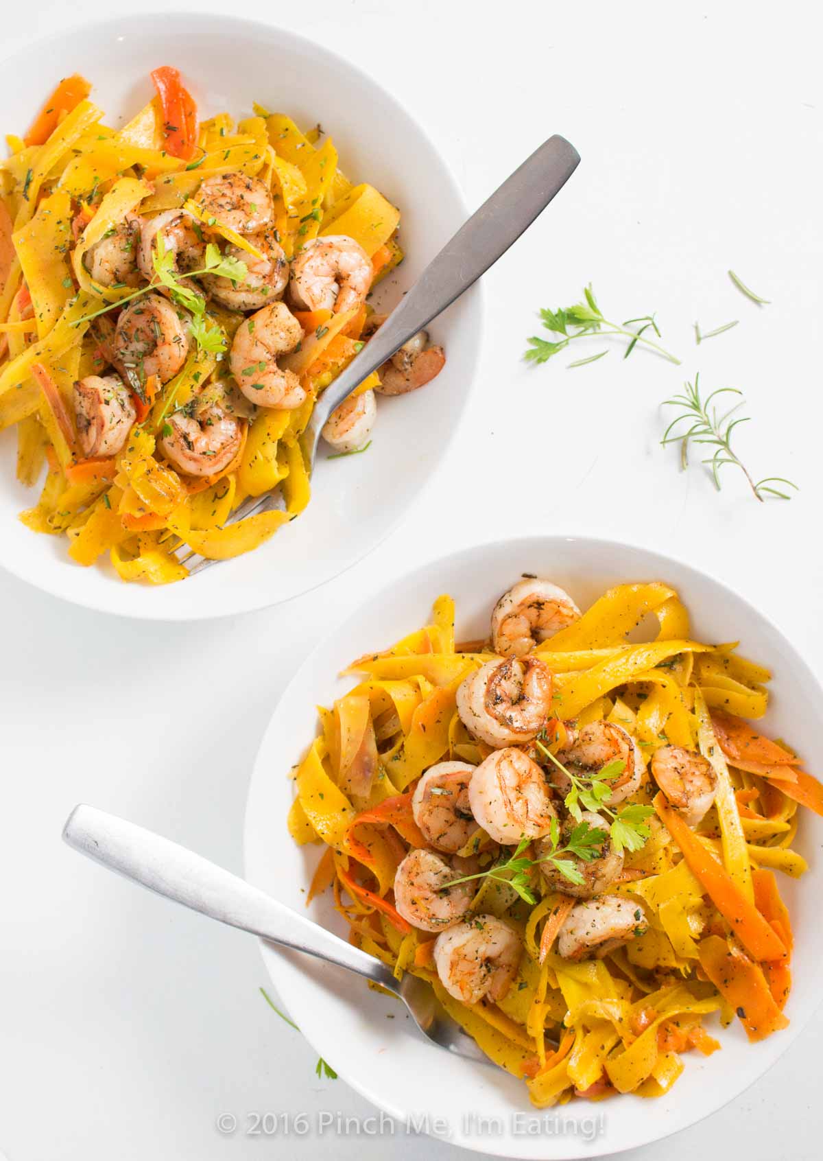 Delicate ribbons of carrots are tossed in browned butter with parsley, sage, rosemary, and thyme and topped with shrimp to make a fresh, flavorful, beautiful, and healthy meal. Paleo and gluten free too! | www.pinchmeimeating.com