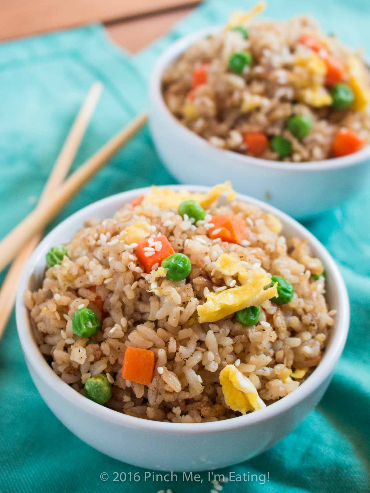 Who needs takeout when you can whip up this easy vegetable fried rice at home? All ingredients are easy to keep on hand so you can make some whenever you'd like! | www.pinchmeimeating.com