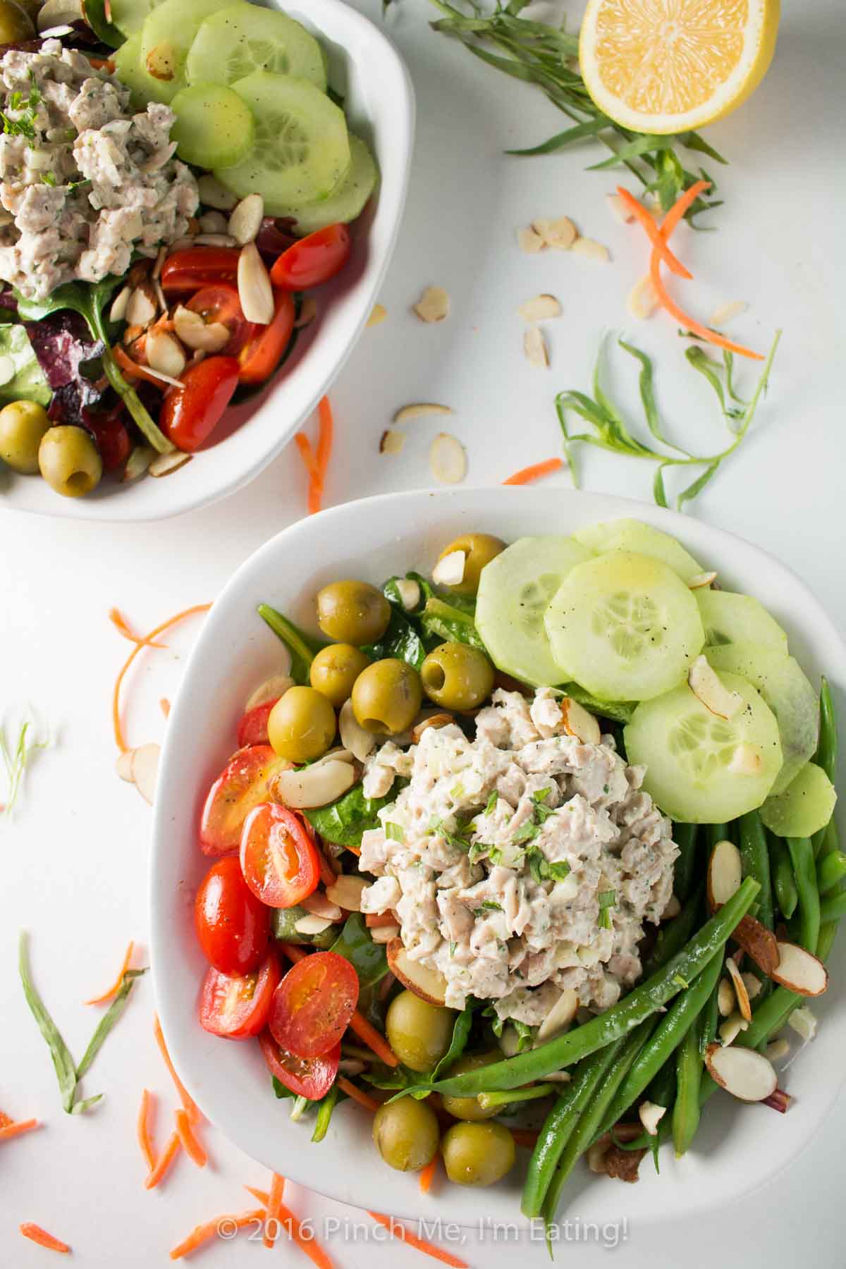 Inspired by a salad from the historic district of Old Montreal, this dinner salad is light, fresh, and perfect for dining al fresco at your own home! Topped with lemon tarragon chicken salad and a champagne vinaigrette. | www.pinchmeimeating.com