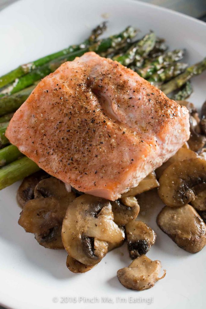 One-pan salmon with asparagus, mushrooms, and balsamic brown butter sauce is the easiest, most delicious dinner - and it's ready in only 20 minutes! This is my new favorite meal! | www.pinchmeimeating.com