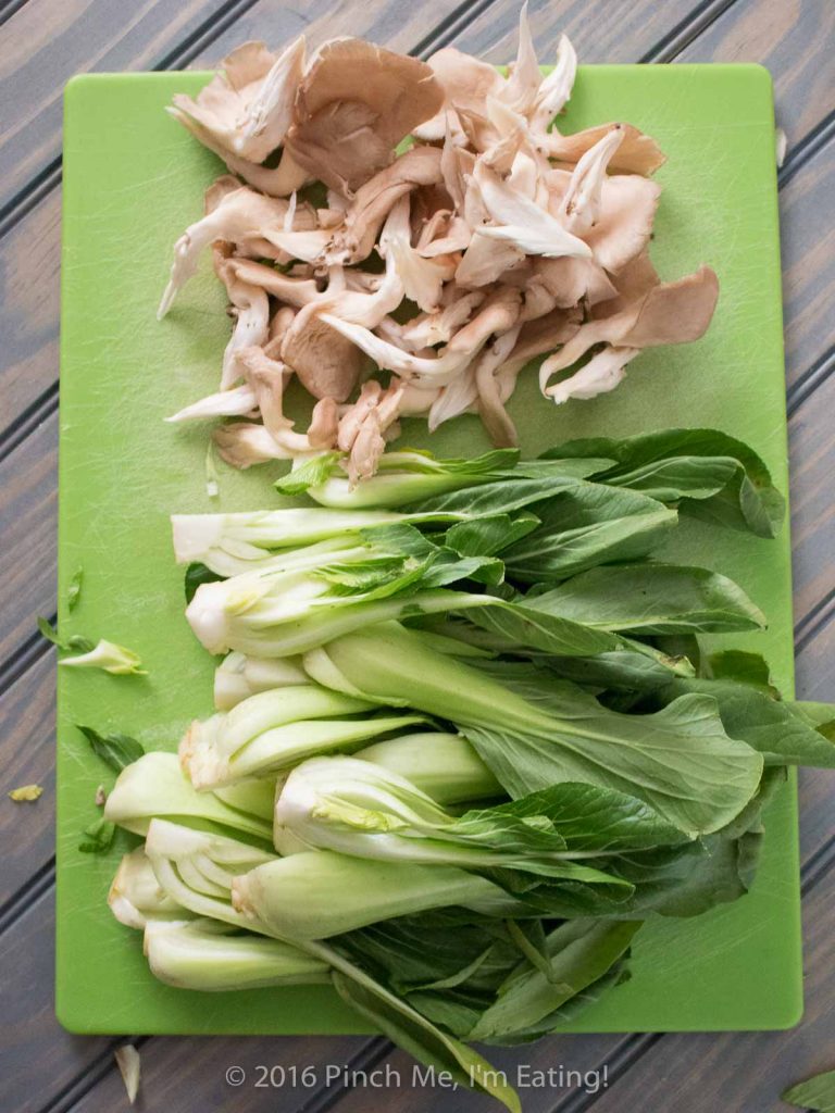 The quickest shallow-fried chicken bites served with adorable baby bok choy and oyster mushrooms in a brothy ginger-garlic sauce. So delicious! It's great with fried rice! | www.pinchmeimeating.com