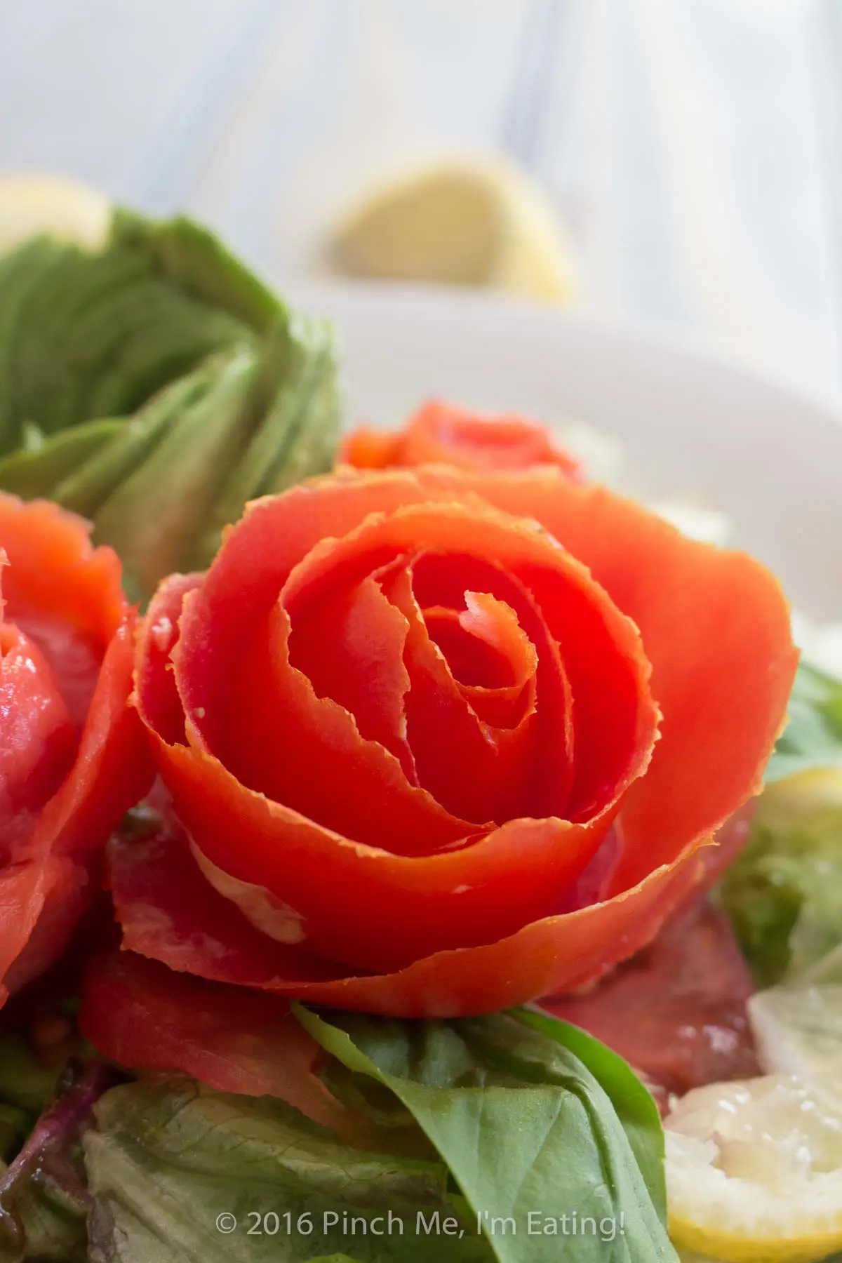 Closeup of an edible rose made from a spiraled tomato.