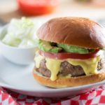 These juicy, aromatic gourmet turkey burgers topped with tomato, avocado, and Hollandaise sauce will make you feel like you're relaxing at an outdoor cafe! | www.pinchmeimeating.com