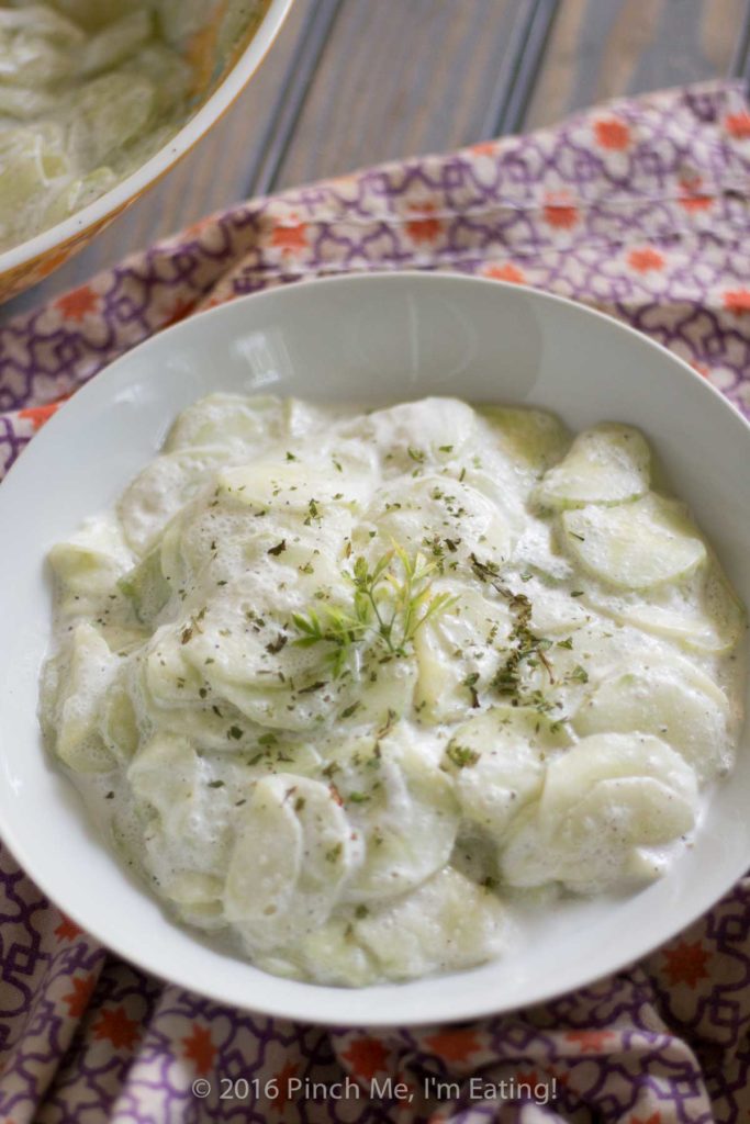 This creamy German cucumber salad, or Gurkensalat, is the perfect companion side dish for bratwurst or burgers. Tangy, sweet, and fresh, it's a deliciously easy summer salad. | www.pinchmeimeating.com