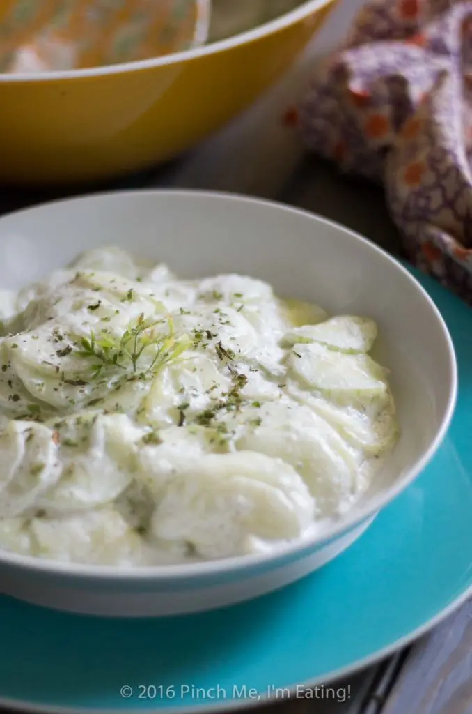 This creamy German cucumber salad, or Gurkensalat, is the perfect companion side dish for bratwurst or burgers. Tangy, sweet, and fresh, it's a deliciously easy summer salad. | www.pinchmeimeating.com