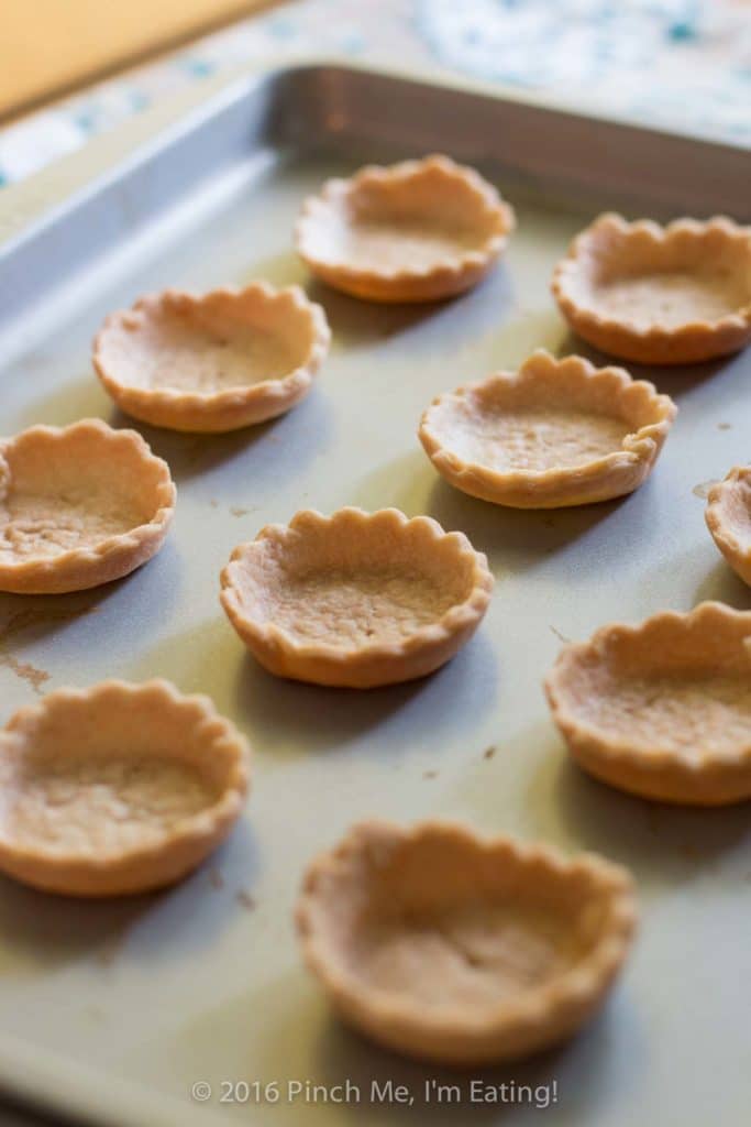 Bite-sized jam and brie tartlets combine melty cheese and your favorite jam for an irresistibly adorable appetizer you can serve at your next wine and cheese party. You'll have a hard time saving some of these canapés for your guests! This recipe uses Brazilian jabuticaba jam, but you can use your favorite kind or even multiple flavors of jam for a variety plate! | www.pinchmeimeating.com