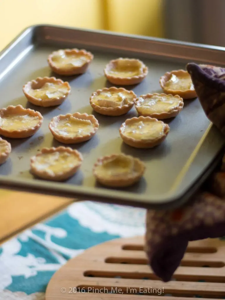 Bite-sized jam and brie tartlets combine melty cheese and your favorite jam for an irresistibly adorable appetizer you can serve at your next wine and cheese party. You'll have a hard time saving some of these canapés for your guests! This recipe uses Brazilian jabuticaba jam, but you can use your favorite kind or even multiple flavors of jam for a variety plate! | www.pinchmeimeating.com