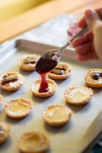 Bite-sized jam and brie tartlets combine melty cheese and your favorite jam for an irresistibly adorable appetizer you can serve at your next wine and cheese party. You'll have a hard time saving some of these canapés for your guests! This recipe uses Brazilian jabuticaba jam, but you can use your favorite kind or even multiple flavors of jam for a variety plate! | www.pinchmeimeating.com