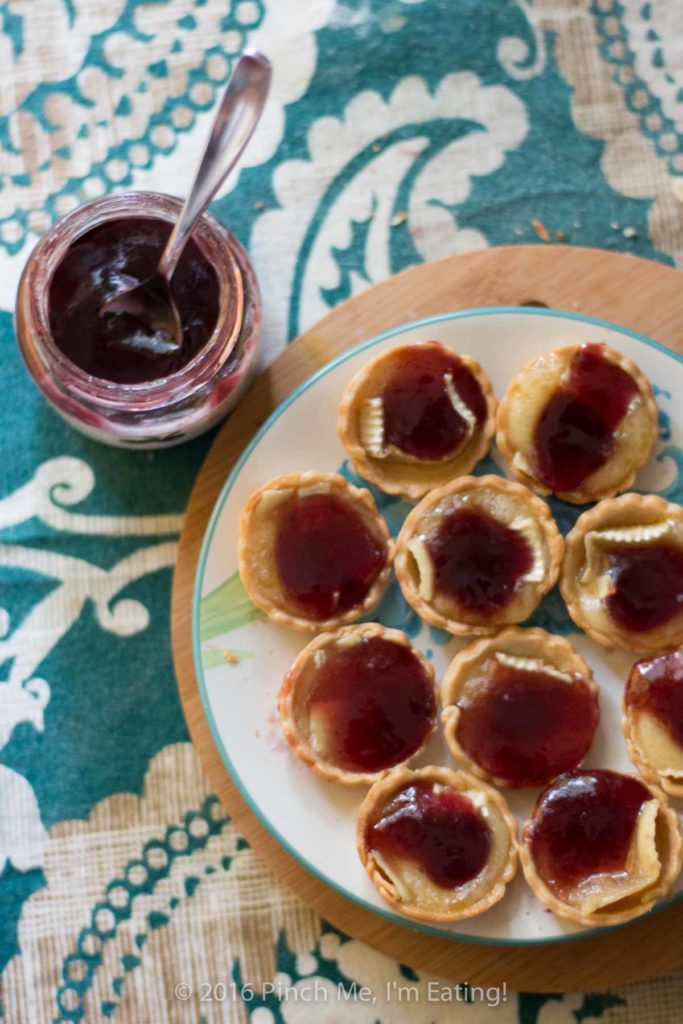 Bite-sized jam and brie tartlets combine melty cheese and your favorite jam for an irresistibly adorable appetizer you can serve at your next wine and cheese party. You'll have a hard time saving some of these canapés for your guests! This recipe uses Brazilian jabuticaba jam, but you can use your favorite kind or even multiple flavors of jam for a variety plate! | www.pinchmeimeating.com