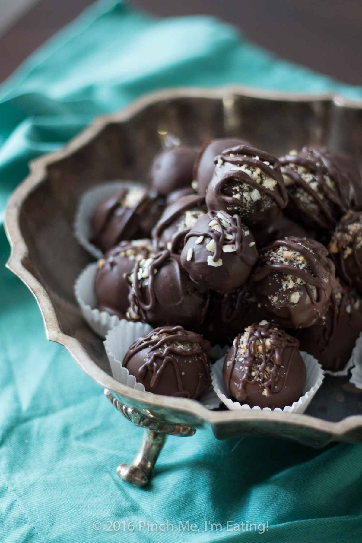 Chocolate bonbons displayed in a metal bowl.