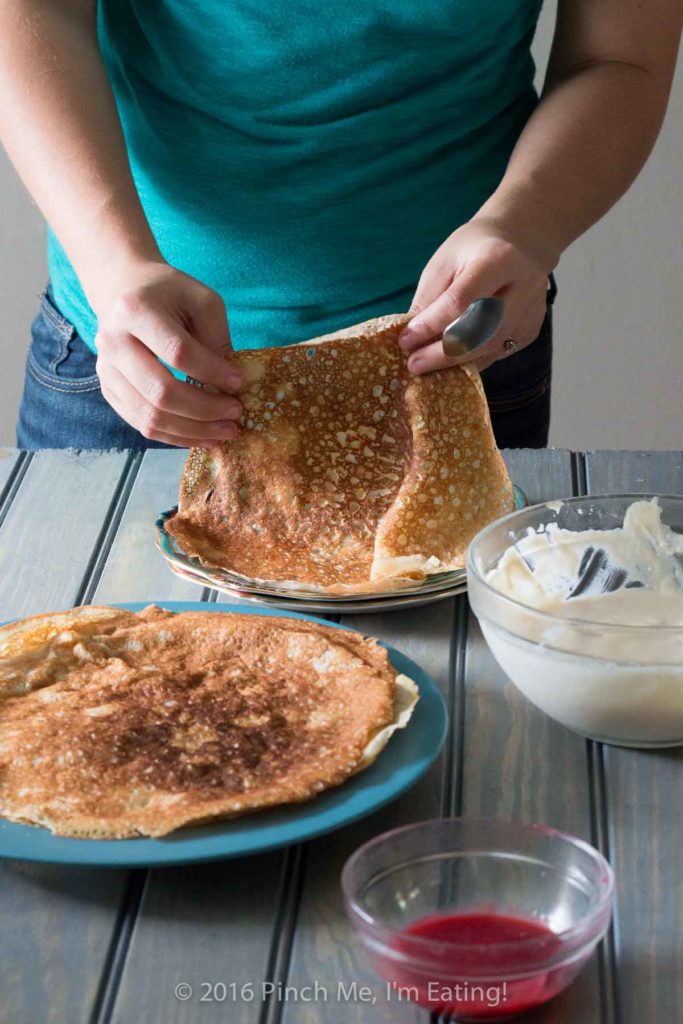 Lemon ricotta crêpes with raspberry sauce make an elegant brunch dish that's easier than it looks, and are a great way to use lemon curd! | www.pinchmeimeating.com