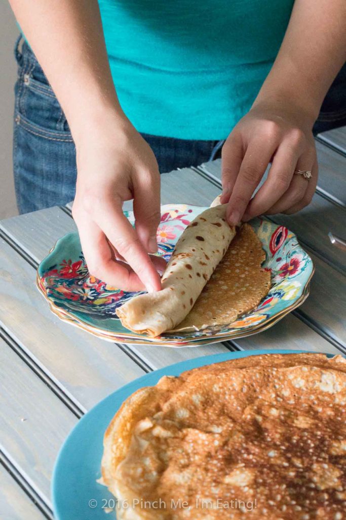 Lemon ricotta crêpes with raspberry sauce make an elegant brunch dish that's easier than it looks, and are a great way to use lemon curd! | www.pinchmeimeating.com