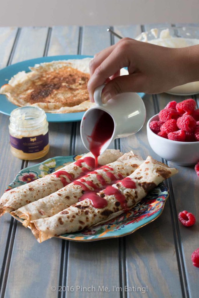 Lemon ricotta crêpes with raspberry sauce make an elegant brunch dish that's easier than it looks, and are a great way to use lemon curd! | www.pinchmeimeating.com