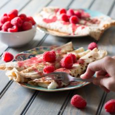 Lemon ricotta crêpes with raspberry sauce make an elegant brunch dish that's easier than it looks, and are a great way to use lemon curd! | www.pinchmeimeating.com