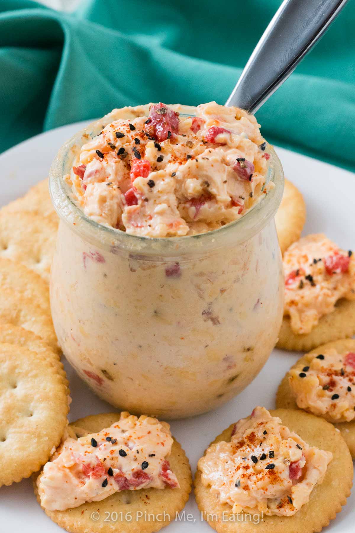 Easy homemade pimento cheese in a Weck jar surrounded by Ritz crackers.