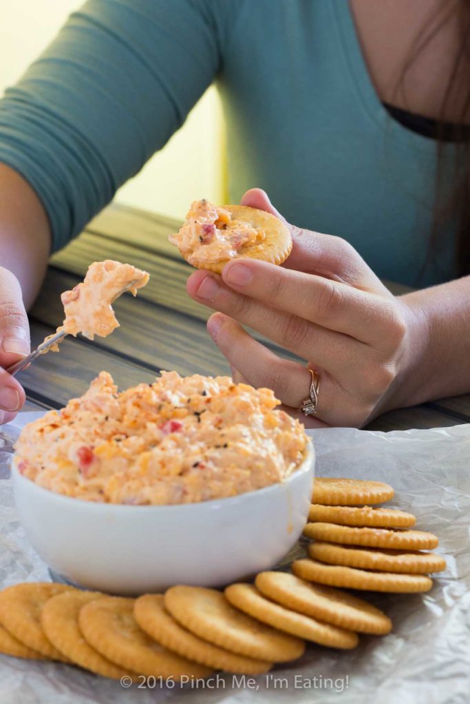 With ample seasonings and just a little kick, creamy Southern pimento cheese is great with everything from crackers or burgers to crab cakes or grits! This cheddar cheese spread also makes a great cold party appetizer dip that doesn't require the oven.