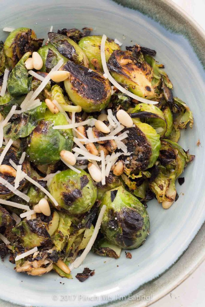 Pan-roasted lemon garlic Parmesan Brussels sprouts with pine nuts are an easy, healthy side dish you can make on the stove in about 15 minutes.