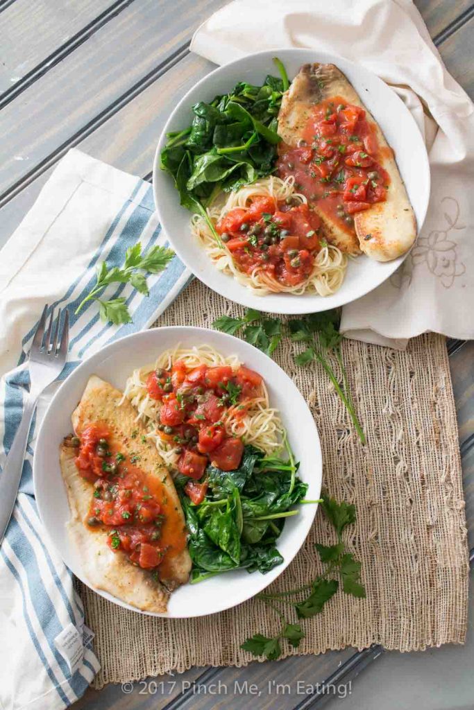 Tilapia with tomatoes and capers is easy to make for a weeknight dinner, healthy, and full of flavor! Serve it with wilted spinach, angel hair pasta, or both.