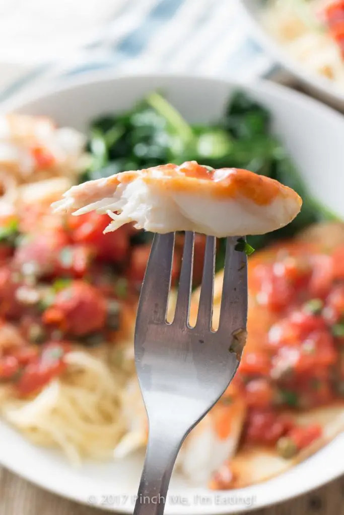 Tilapia with tomatoes and capers is easy to make for a weeknight dinner, healthy, and full of flavor! Serve it with wilted spinach, angel hair pasta, or both.