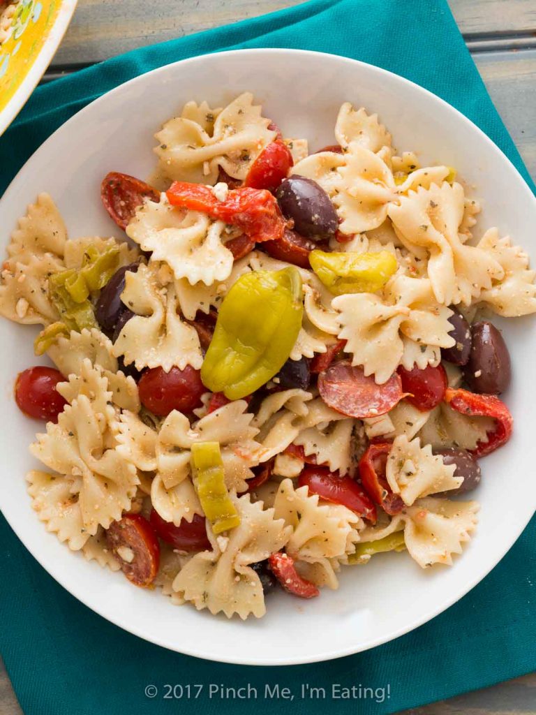 Greek bowtie pasta salad in a white bowl