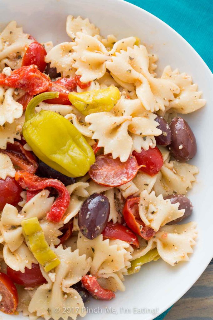 Greek pasta salad with feta, pepperoncinis, kalamata olives, tomatoes, and roasted red peppers