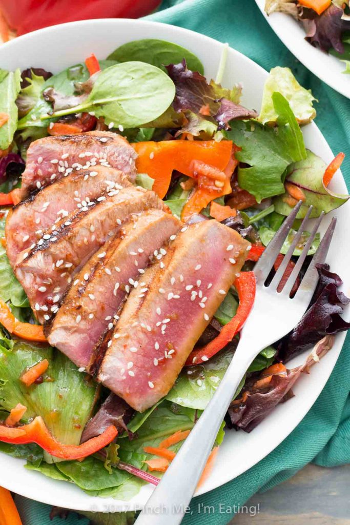 This mixed greens salad with bell peppers and a soy ginger vinaigrette is topped with a seared tuna steak for a light and refreshing spring or summer lunch!