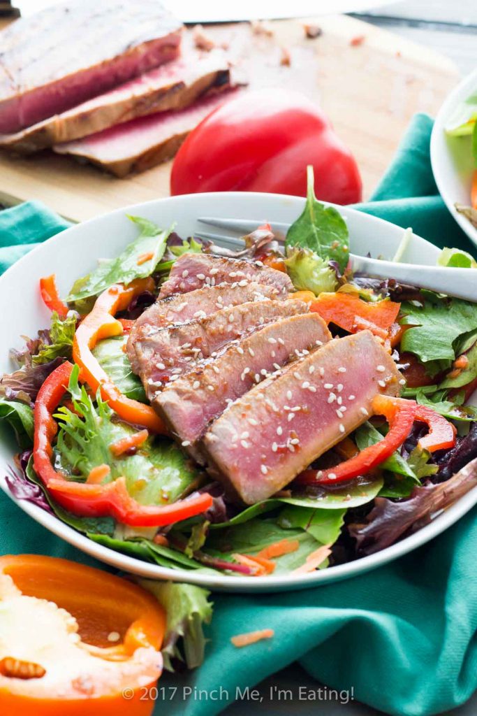This mixed greens salad with bell peppers and a soy ginger vinaigrette is topped with a seared tuna steak for a light and refreshing spring or summer lunch! 