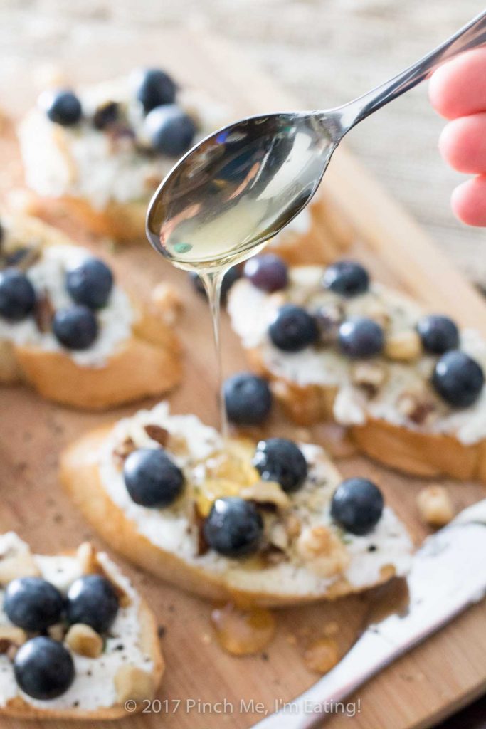 Ricotta crostini with blueberries, walnuts, honey, and thyme is an unexpected and delightful appetizer perfect for serving with wine and cheese!