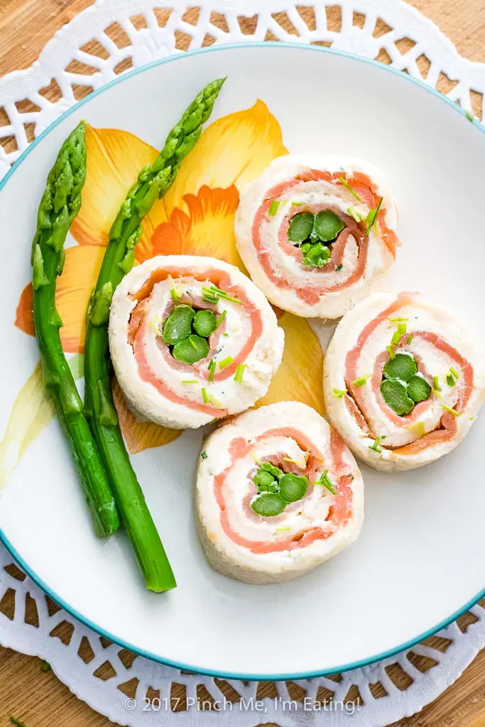 Overhead shot of smoked salmon and asparagus pinwheel tea sandwiches