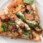 Looking for a unique gourmet pizza? Balsamic chicken pizza with blue cheese and spinach on an olive oil and garlic base might be just the thing!