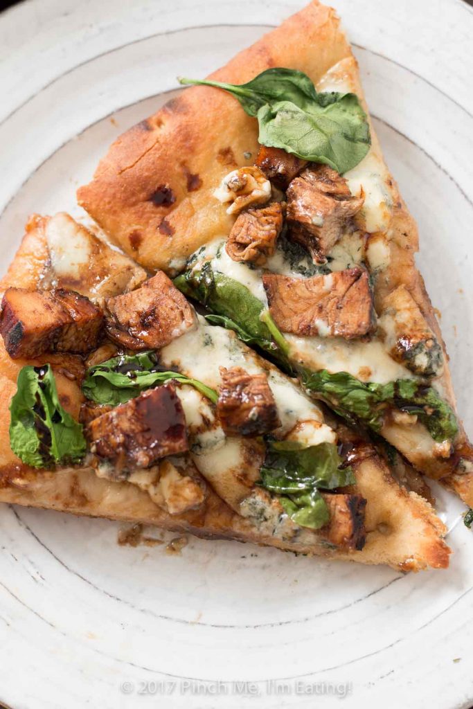 Looking for a unique gourmet pizza? Balsamic chicken pizza with blue cheese and spinach on an olive oil and garlic base might be just the thing!