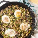 Brussels sprout hash with pancetta, mushrooms, and an egg on top is perfect for breakfast OR dinner, served with cheesy grits!
